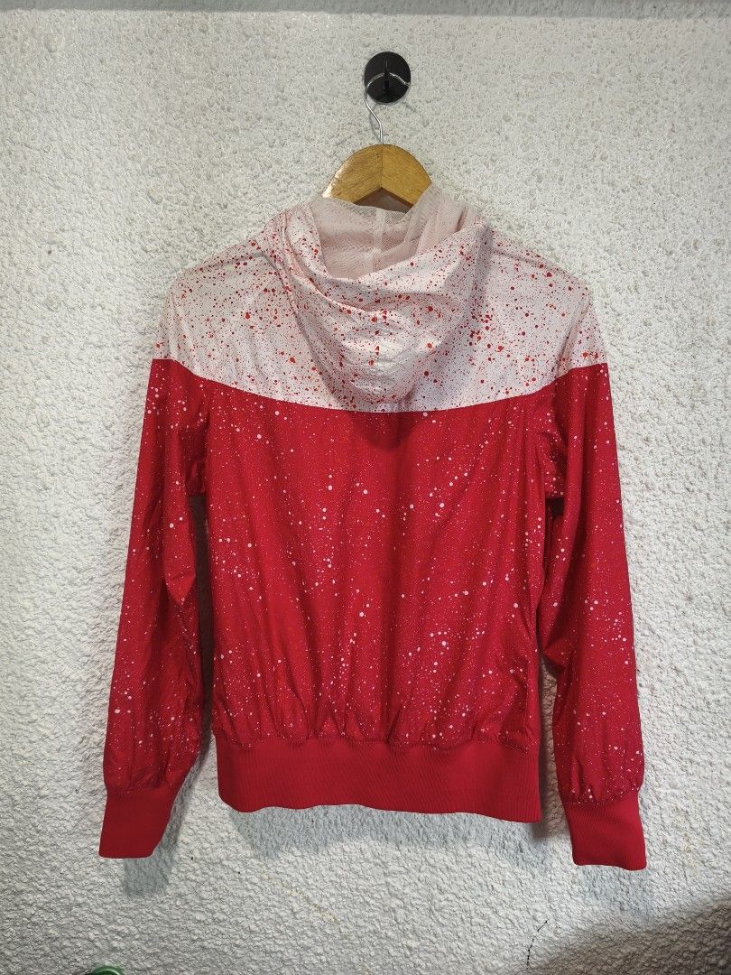 Nike Windbreaker Jacket Red Splatter Print (Category: Coats, Jackets and Outerwear) located in Iloilo. Submitted by daddy_declutter (Listing ID 1456285150, Image 2). Description: Dimes: L 25 x W 20 Cool Nike windbreaker jacket, red and white with splatter paint. Features a hood, zip-up front, and side pockets. Unique Nike shoe charm zipper pull. Perfect for casual style..