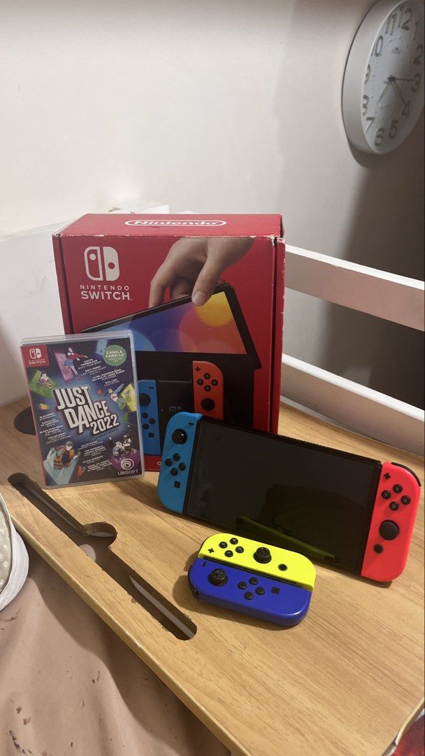 Nintendo Switch OLED with 2 Joycons and Game (Category: Nintendo) located in Manila. Submitted by florencetechsolutionsph (Listing ID 1456350133, Image 1). Description: Negotiable - Nintendo Switch OLED - Original Box Included - Just Dance 2022 (or EA FC) - With case for switch - Extra Yellow & Blue Joycons RFS: Di na ginagamit .