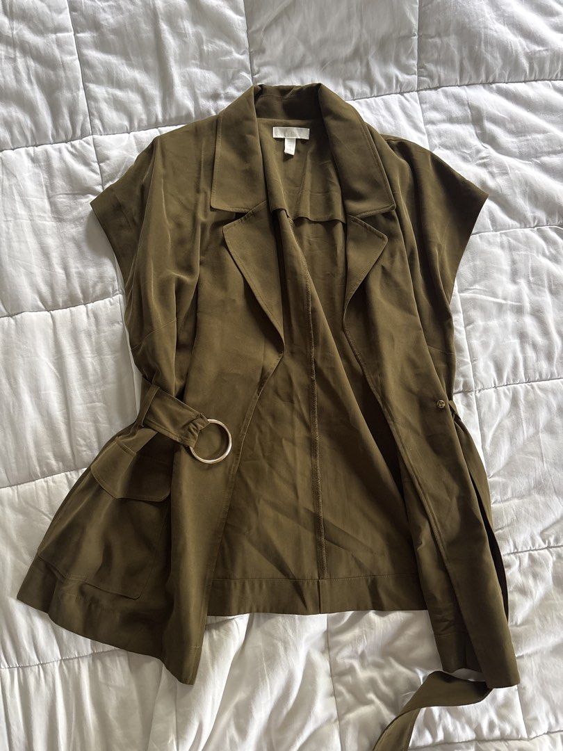 Olive Green Vest Jacket with Belt (Category: Coats, Jackets and Outerwear) located in Muntinlupa City. Submitted by shmeesh (Listing ID 1456233990, Image 1). Description: - Loft sleeveless vest jacket - Chic olive green color - Includes matching belt with gold ring detail - Features two functional front pockets - Perfect for layering to add polish and structure.