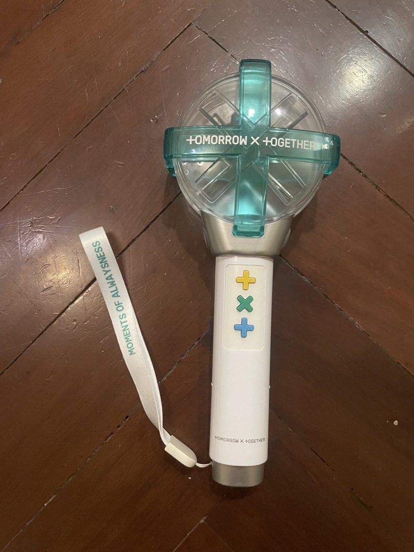 (OPENED) TXT OFFICIAL LIGHTSTICK Version 1 W/ COMPLETE PC SET (Category: K-Wave Merchandise) located in Manila. Submitted by erigehierheh (Listing ID 1456385253, Image 2). Description: LOCATION: QUEZON CITY MOP: GCash MOD: J&T or Grab (SF shouldered by Buyer) ーーーーー Group: TXT Type: Lightstick Condition: Lightstick is in good condition, box is slightly damaged. Most photocards are in good condition, but Taehyun’s has scratches. Name: TXT Official 