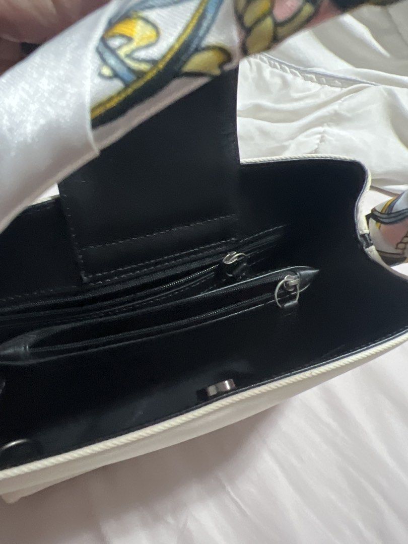 Original Coach White and Black Canvas Handbag with Scarf Handle (Category: Shoulder Bags) located in Cavite. Submitted by corp22 (Listing ID 1456237694, Image 2). Description: - Original Coach handbag - White and black canvas with black leather base and trim - Unique colorful scarf-wrapped handles - Organized interior with zippered pockets - Clean condition - Ideal for everyday use.