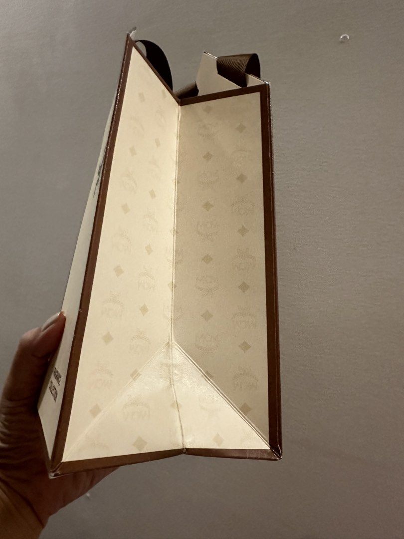 Original MCM Perfume Paperbag (Category: Tote Bags) located in Quezon City. Submitted by declutter_with_ericka (Listing ID 1456238736, Image 3). Description: MCM Perfume Paper Bag Size: Extra Small Width: 10cms Height: 18cms The paperbag can fit 1 box of perfume. The item will be shipped from Katipunan, Quezon City..