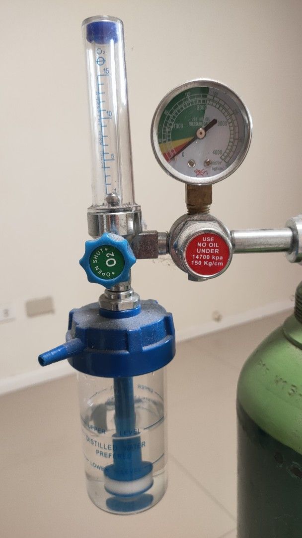Oxygen Tank with Regulator and Humidifier (Category: Medical Supplies & Tools) located in Las Pinas. Submitted by drewlukas (Listing ID 1456273528, Image 1). Description: - Green oxygen tank - Includes regulator and humidifier (with water) - Pressure gauge visible - Comes with tubing - Ready for immediate use.