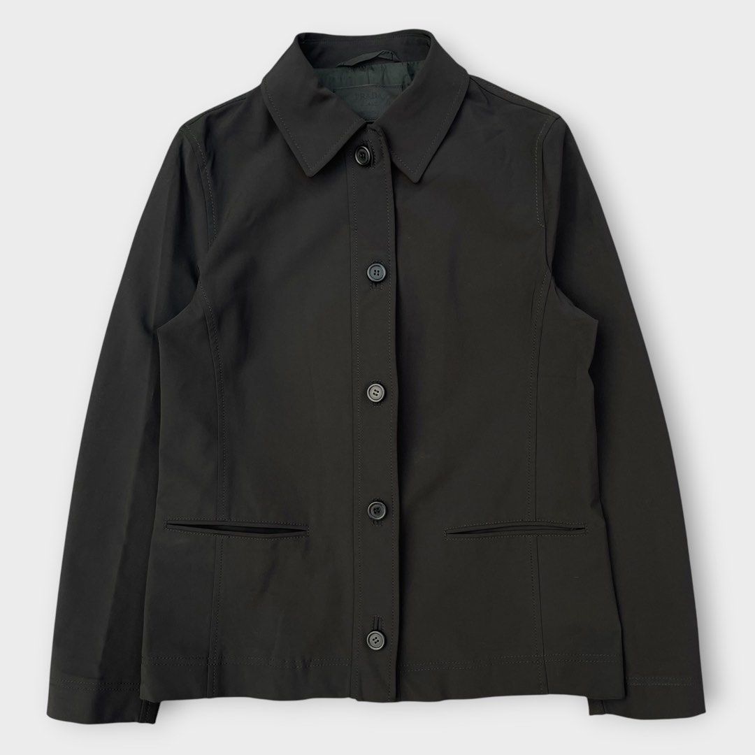 Prada - Vintage - 90s Single-breasted Nylon Jacket (Category: Coats, Jackets and Outerwear) located in Los Banos. Submitted by declutterking (Listing ID 1456415387, Image 1). Description: Size 40 on tag • 2 front pockets • 95% nylon Dimensions: 14.75" shoulders 18" chest 25" length 23.5" sleeves Good as new condition Authentic.
