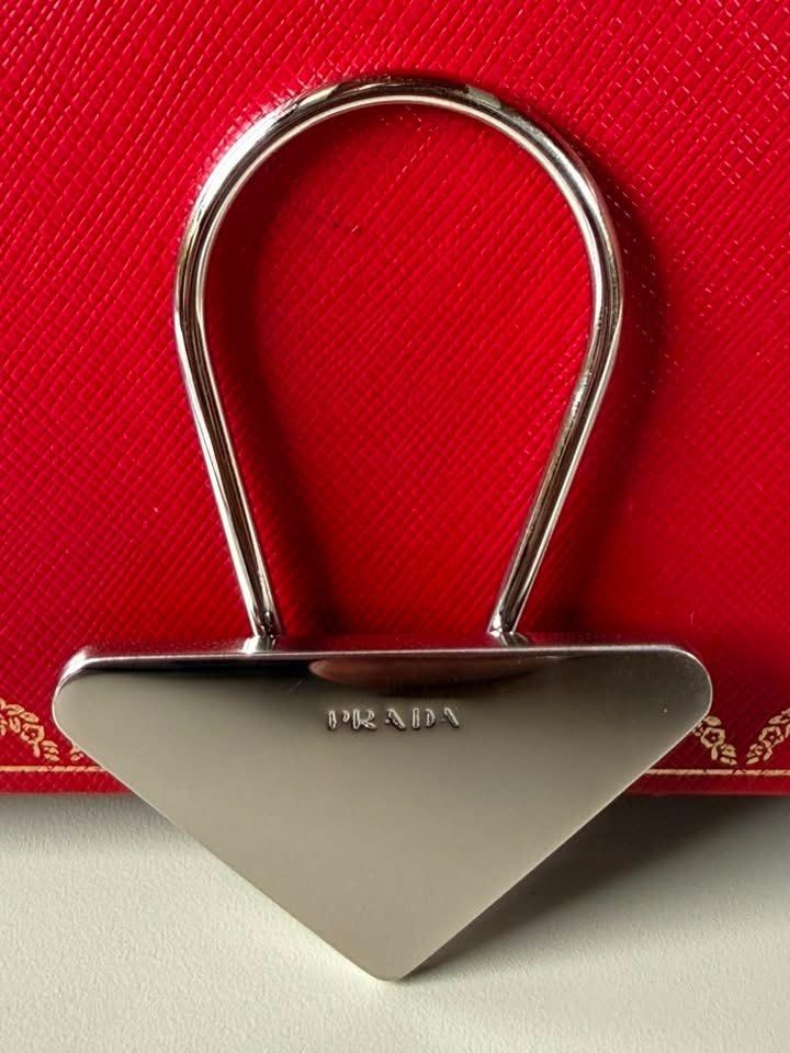 Prada Key Holder (Category: Luxury Accessories) located in Quezon City. Submitted by liezl.marie (Listing ID 1456305855, Image 1). Description: Authentic vintage Pr@da silver-tone metal triangle logo clip key holder. 4500 Open for layaway. Disclaimer: We are not affiliated, associated, authorized, endorsed by or in any way officially connected with any other company or luxury brand. All copyrights are reserved to the original brand..