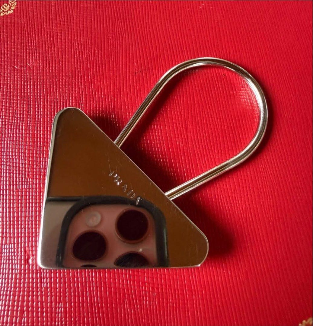 Prada Key Holder (Category: Luxury Accessories) located in Quezon City. Submitted by liezl.marie (Listing ID 1456305855, Image 2). Description: Authentic vintage Pr@da silver-tone metal triangle logo clip key holder. 4500 Open for layaway. Disclaimer: We are not affiliated, associated, authorized, endorsed by or in any way officially connected with any other company or luxury brand. All copyrights are reserved to the original brand..
