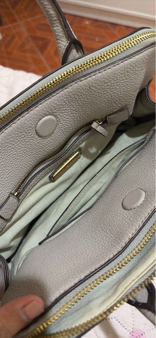 Preloved authentic Tory Burch Grey Leather Satchel Handbag (Category: Luxury Bags & Wallets) located in Binangonan. Submitted by thingsbymargs (Listing ID 1456411135, Image 3). Description: Light gray/taupe color Small tote 3 compartments No sling Signs of usage but no issues, all parts are intact Free shipping Can negotiate but not free SF Please pm for more pics and if interested RFS: decluttering, not used for a long time.