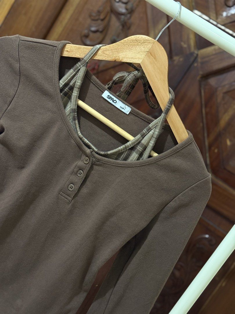 SPAO Brown Long Sleeve Top with Plaid Inner Layer (Category: Longsleeves) located in Iloilo. Submitted by wornwellco (Listing ID 1456295202, Image 2). Description: - SPAO brown long-sleeved top - Size L (fits like L) - Cute plaid inner layer visible at neckline - Button details on the front - Versatile for layering or wearing alone - Comfortable and stylish design.