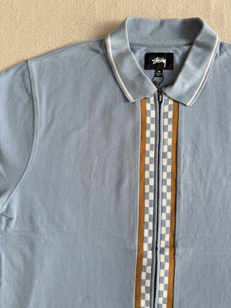 Stussy Zip Polo Shirt (Category: Tshirts & Polo Shirts ) located in Manila. Submitted by porma.market (Listing ID 1456374649, Image 3). Description: - Blue Stussy polo shirt - Checkerboard stripe down the front zipper - White and brown trim on collar and cuffs - Stussy logo embroidered on sleeve - 100% Cotton - Size M.