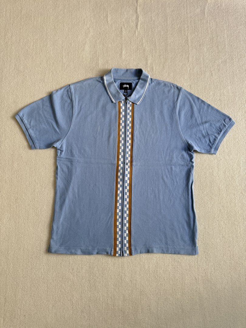 Stussy Zip Polo Shirt (Category: Tshirts & Polo Shirts ) located in Manila. Submitted by porma.market (Listing ID 1456374649, Image 1). Description: - Blue Stussy polo shirt - Checkerboard stripe down the front zipper - White and brown trim on collar and cuffs - Stussy logo embroidered on sleeve - 100% Cotton - Size M.