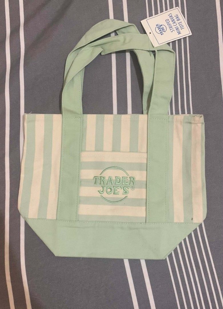 Trader Joe's Mini Canvas Striped Tote Bag (Category: Tote Bags) located in Cavite. Submitted by shielag76 (Listing ID 1456333006, Image 3). Description: - Cute mini tote bag from Trader Joe's 🍏 Green 🩷 Pink 🔵 Blue - Small front pocket with embroidered Trader Joe's logo - Ideal for carrying small essentials.
