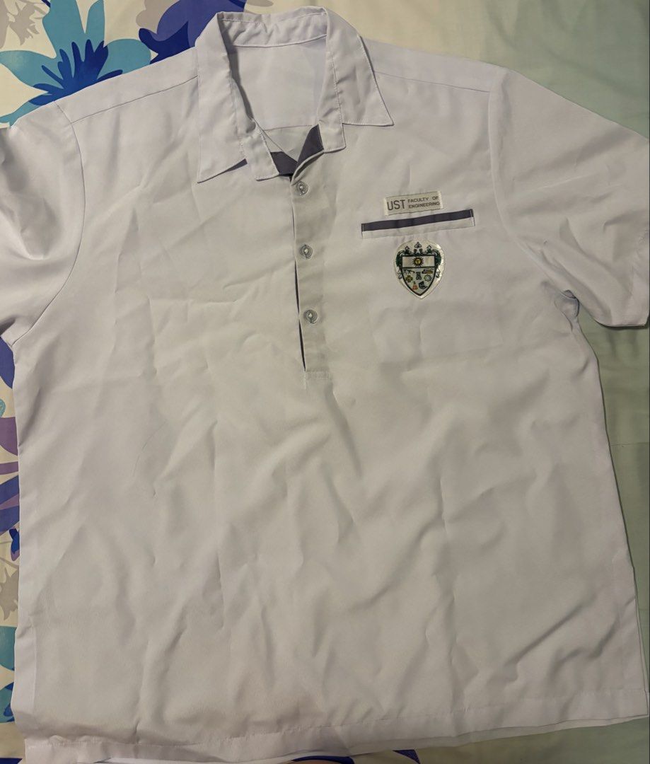 UST Faculty of Engineering Polo Shirt (Category: Tshirts & Polo Shirts ) located in Quezon City. Submitted by beauty_eunice (Listing ID 1456283366, Image 1). Description: - UST Faculty of Engineering white polo shirt - Short sleeves with button-up neckline - Features UST Engineering crest on chest pocket - Ideal for school wear or official events - Comfortable and classic design.
