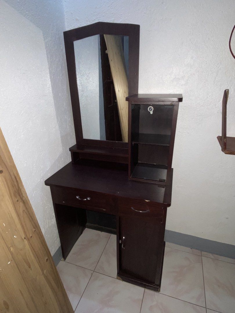 Vanity Dressing Table with Mirror and Cabinet (Category: Tables & Sets) located in Manila. Submitted by denisegol91095 (Listing ID 1456282471, Image 2). Description: - Dark wood dressing table - Includes a mirror - Small cabinet with glass door - One top drawer - One bottom cabinet door - Plenty of storage space for makeup and accessories - Stylish addition to any bedroom 📌 Very sturdy .