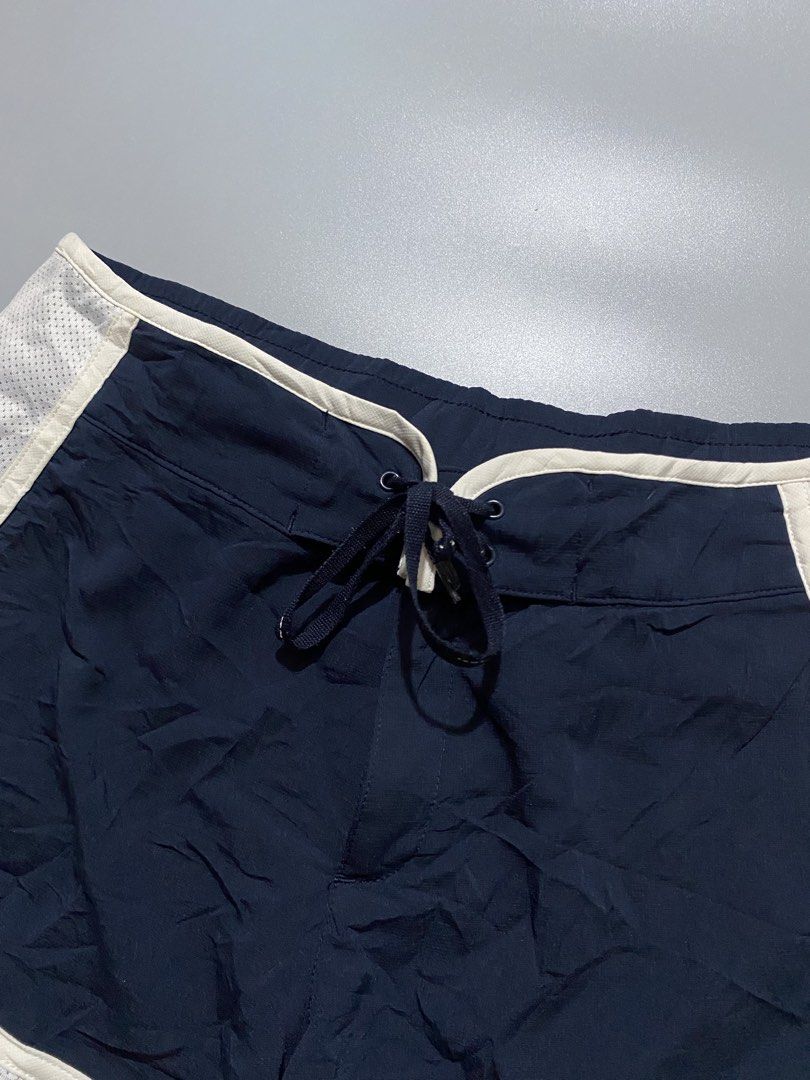 Vintage nike (Category: Shorts) located in Manila. Submitted by delunakenn94368 (Listing ID 1456234818, Image 3). Description: - Navy blue Nike running shorts - White mesh side panels with large 'NIKE' graphic - Adjustable drawstring waist - Small Nike swoosh logo on the front - Ideal for running, workouts, or casual wear.