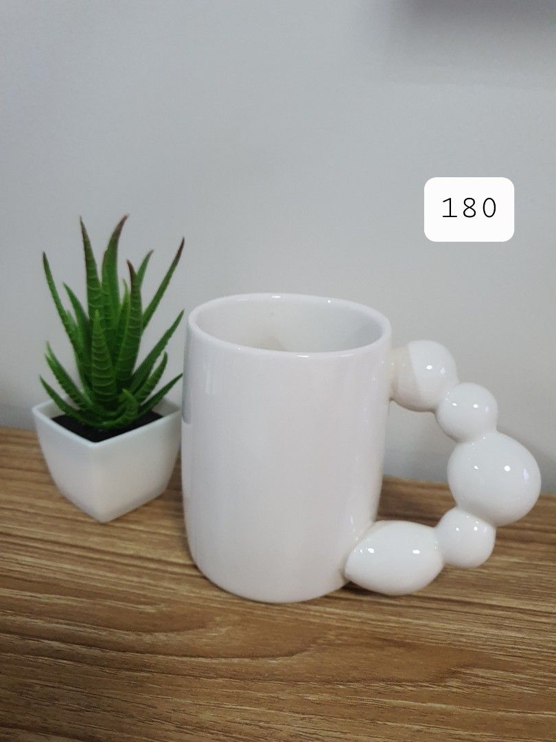 White Ceramic Mug with Unique Bubble Handle (Category: Coffee & Tea Tableware) located in Quezon City. Submitted by cheche14 (Listing ID 1456330588, Image 1). Description: - Adorable white ceramic mug - Features a unique and fun bubble handle - Ideal for your morning coffee or tea - Makes a great gift or addition to your collection - Dimensions: Approx. [height] tall x [diameter] wide.