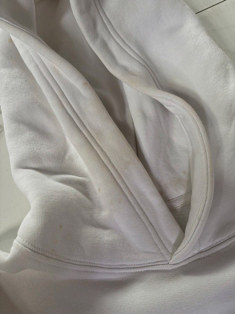 White Guess Jeans Hoodie (Category: Hoodies) located in Manila. Submitted by izzmya (Listing ID 1456238011, Image 3). Description: - Can fit s-m - White Guess Jeans hoodie - Features classic 'GJ' logo with 'Guess Jeans Registered Trademark Since 1981' text - Front kangaroo pocket - Note: Some light yellowing/stains inside the hoodie area.