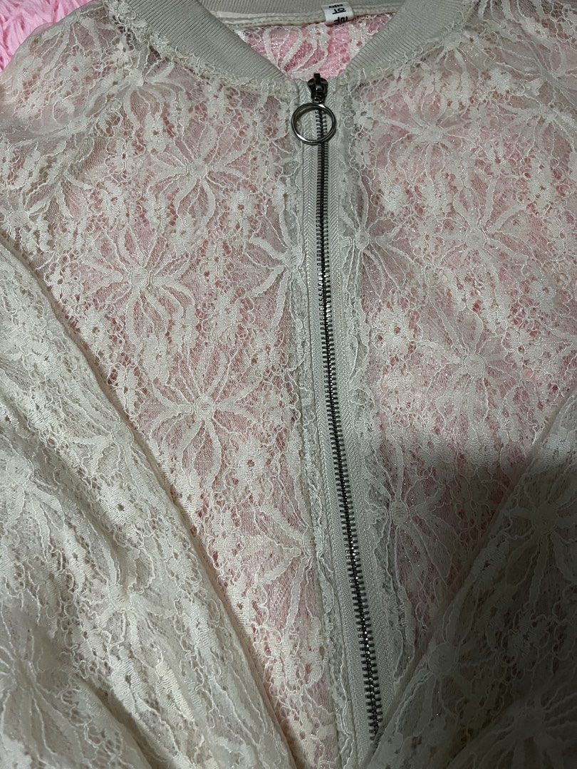 White Lace Bomber Jacket (Category: Coats, Jackets and Outerwear) located in Tabuk. Submitted by zenwolf-1867 (Listing ID 1456331799, Image 3). Description: - Sheer white lace bomber jacket - Pink lining underneath - Zipper front closure with a ring pull - Ribbed collar, cuffs, and hem - Perfect for layering over camis or bralettes.