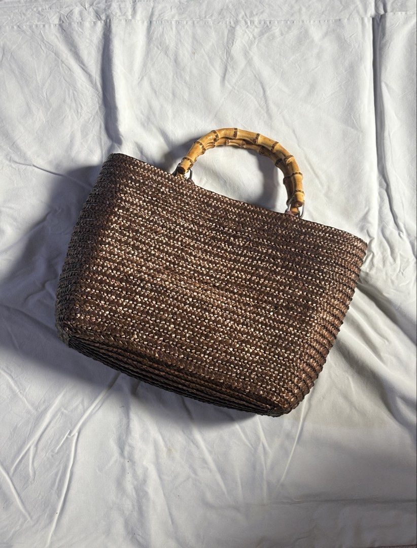 Woven Tote Bag with Bamboo Handles (Category: Tote Bags) located in Manila. Submitted by dalampasiganswim (Listing ID 1456292780, Image 1). Description: - Chic brown woven tote bag - Unique bamboo handles - Secure magnetic snap closure - Lined with dark brown fabric - Ideal for everyday use and carrying essentials.