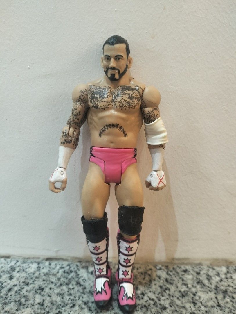 WWE CM Punk Action Figure Pink Gear (Category: Figurines & Statues) located in Cabuyao City. Submitted by boozerboy21 (Listing ID 1456296469, Image 1). Description: - CM Punk action figure - Signature pink gear and boots - Detailed body tattoos - Fully articulated joints for posing - Ideal for wrestling fan collections.