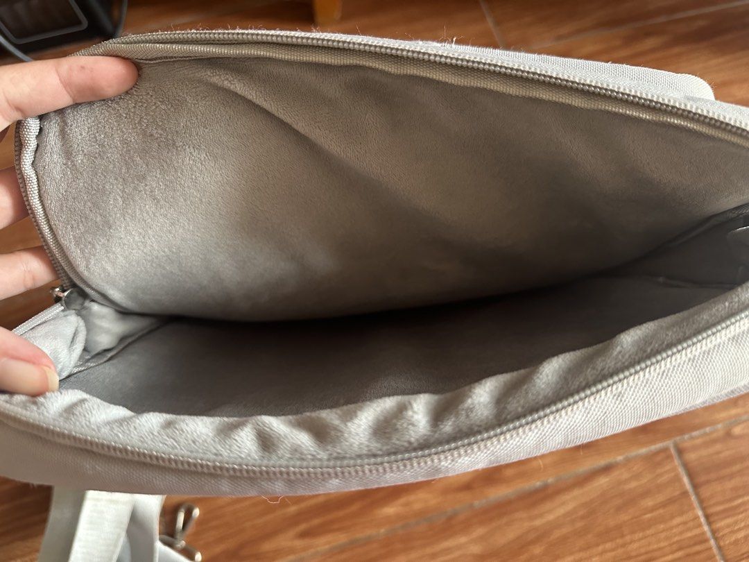15.6” Light Grey Laptop Bag with Shoulder Strap and Pockets (Category: Laptop Bags & Sleeves) located in San Jose del Monte. Submitted by jaliebee (Listing ID 1456438988, Image 3). Description: - Grey laptop bag - Main compartment for your laptop - Two front pockets for essentials - Detachable shoulder strap for versatile carrying - Zippers are in good working condition - Ample space inside for all your tech needs.