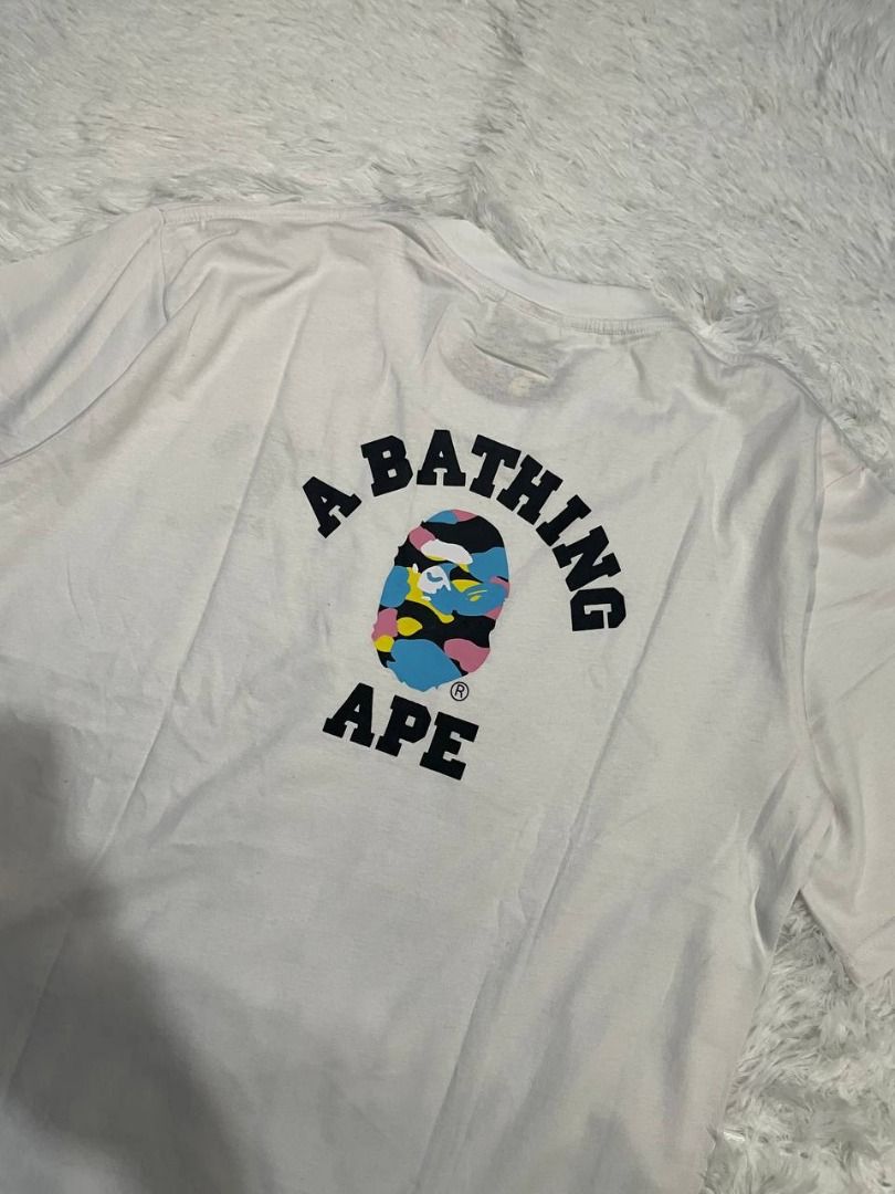 A Bathing Ape BAPE Camo Ape Head Tee White XL (Category: Tshirts & Polo Shirts ) located in Caloocan City. Submitted by shop_tuffgoods (Listing ID 1456509971, Image 3). Description: - Authentic White A Bathing Ape T-Shirt - Size: XL - Features the classic Ape Head logo with a vibrant camo fill - Brand new with original tags attached - Perfect addition to any streetwear collection - Width - 22" - Length - 30".