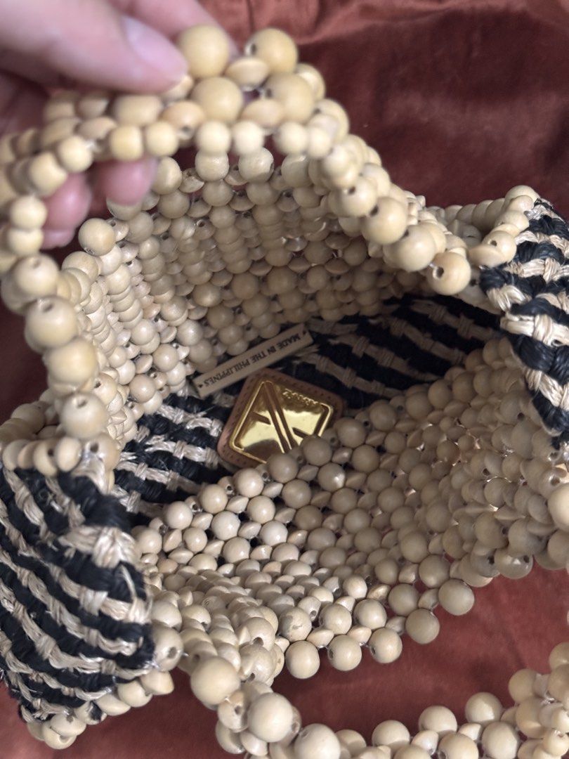Aranaz Lagrima (Category: Purses & Pouches) located in Quezon City. Submitted by prebytonie (Listing ID 1456424779, Image 3). Description: - Brand: Aranaz - Model: Lagrima - Material: Wooden beads, woven fibers - Origin: Made in the Philippines - Design: Unique beaded exterior with woven base - Condition: Excellent, like new - Includes: Original Aranaz dust bag.