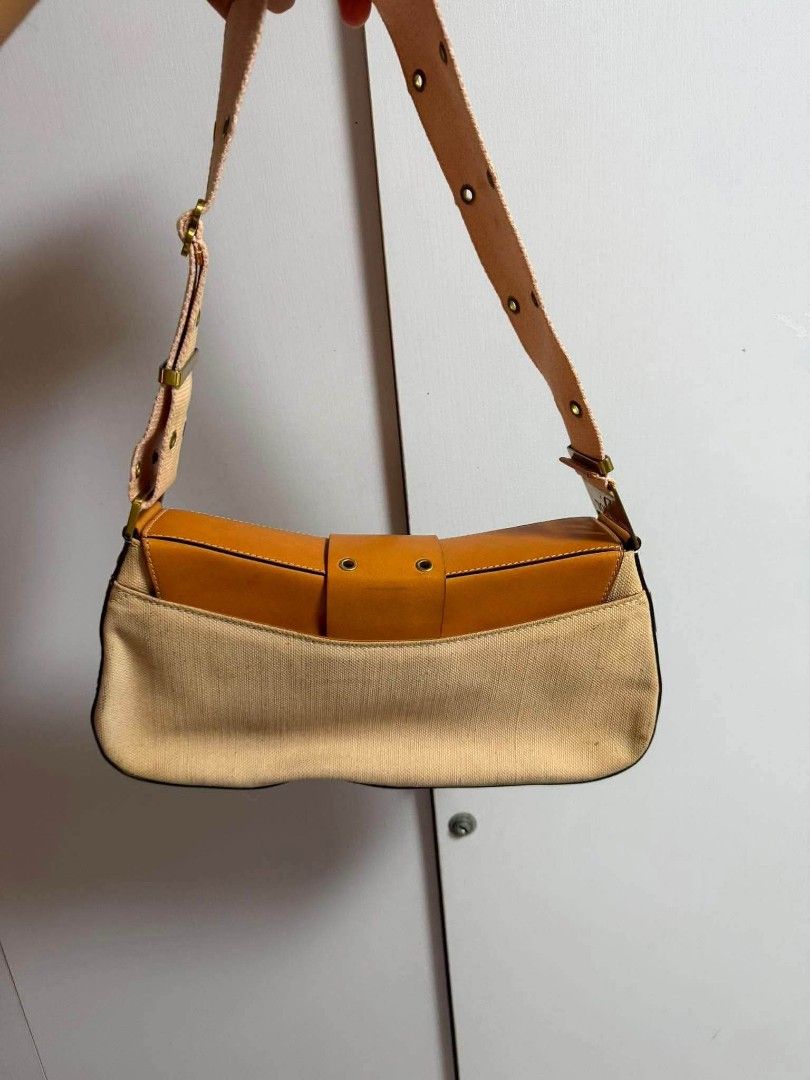 Authentic Christian Dior Canvas & Leather Shoulder Bag (Category: Luxury Bags & Wallets) located in Marikina City. Submitted by aussiemaan (Listing ID 1456529750, Image 2). Description: - Authentic Dior shoulder bag - Beige canvas with tan leather trim - Gold-tone hardware - Dior logo clasp - Adjustable strap with multiple eyelets - Classic and timeless design.