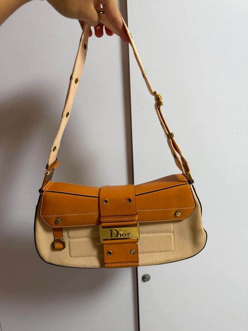 Authentic Christian Dior Canvas & Leather Shoulder Bag (Category: Luxury Bags & Wallets) located in Marikina City. Submitted by aussiemaan (Listing ID 1456529750, Image 1). Description: - Authentic Dior shoulder bag - Beige canvas with tan leather trim - Gold-tone hardware - Dior logo clasp - Adjustable strap with multiple eyelets - Classic and timeless design.
