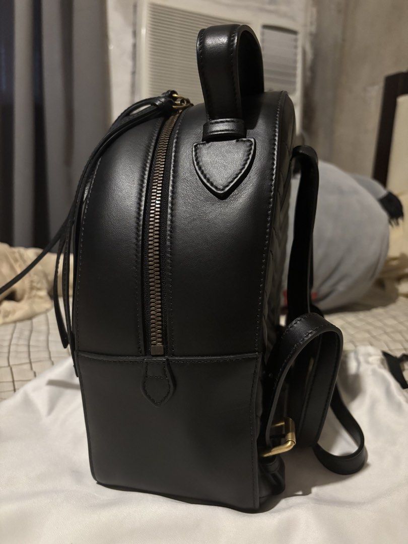 AUTHENTIC Gucci GG Black Leather Marmont Matelasse Backpack (Category: Luxury Bags & Wallets) located in Paranaque City. Submitted by trvlyjxliana (Listing ID 1456588486, Image 3). Description: - Authentic Gucci GG Marmont Backpack - Color: Black Calfskin Leather - Signature Matelasse Chevron Pattern - Gold GG Logo Hardware - Top Handle - Adjustable Shoulder Straps - Zipper Closure - Includes Dust Bag and Authenticity Cards - Ideal for Everyday U