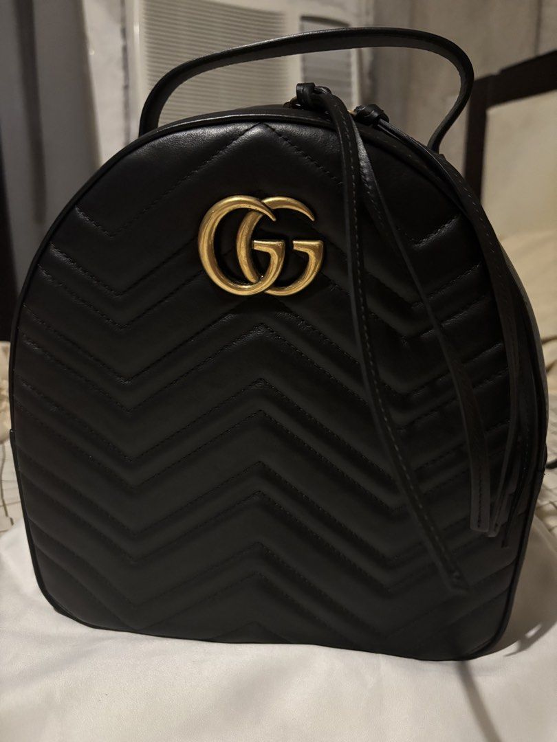 AUTHENTIC Gucci GG Black Leather Marmont Matelasse Backpack (Category: Luxury Bags & Wallets) located in Paranaque City. Submitted by trvlyjxliana (Listing ID 1456588486, Image 2). Description: - Authentic Gucci GG Marmont Backpack - Color: Black Calfskin Leather - Signature Matelasse Chevron Pattern - Gold GG Logo Hardware - Top Handle - Adjustable Shoulder Straps - Zipper Closure - Includes Dust Bag and Authenticity Cards - Ideal for Everyday U