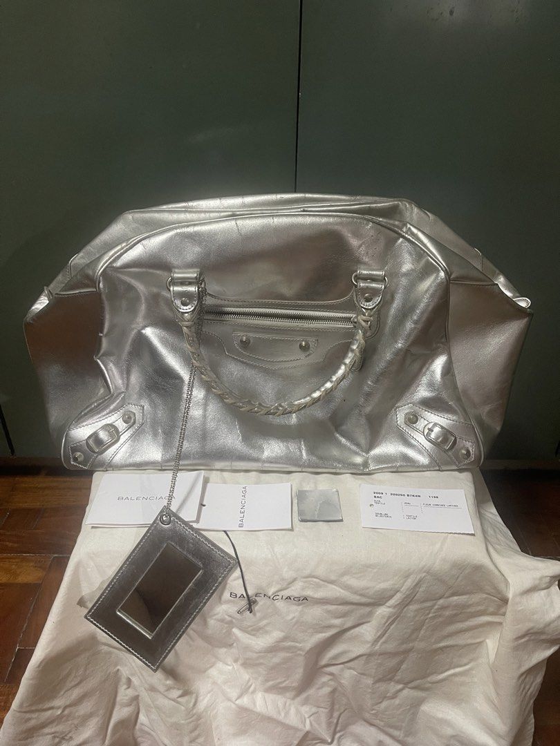 balenciaga bowler gym bag (Category: Luxury Bags & Wallets) located in Quezon City. Submitted by karma_para_sa_bogus (Listing ID 1456574214, Image 1). Description: Bowler Gym-Travel bag.. limited edition silver gray color. with papers, leather swatch, dustbag and mirror.. di na sya perfect ha..may mga rubs and scratches na in some parts pero maganda pa din and very presentable. 48k only. negotiable for sure buyers. pwede magrequest ng pics pero k