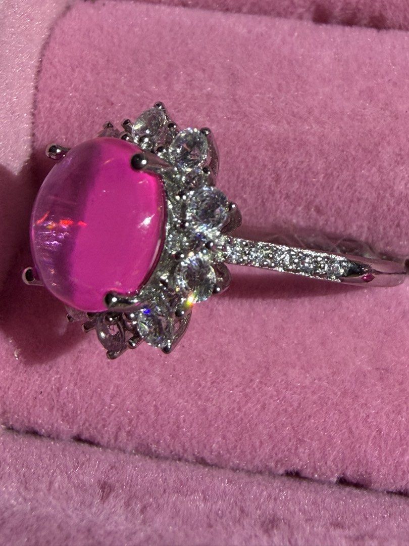 Big cabochon Pink Opal Ring with moisa Stone Accents silver (Category: Rings) located in Orani. Submitted by kr_bowtique (Listing ID 1456544942, Image 2). Description: - Beautiful ring with a large pink opal gemstone. - Surrounded by smaller moisa stones. - Silver band with intricate stone details. - Unique and eye-catching design. - Adds a perfect pop of color to any outfit. - Ideal for special occasions or everyday elegance. -rear and hard to f
