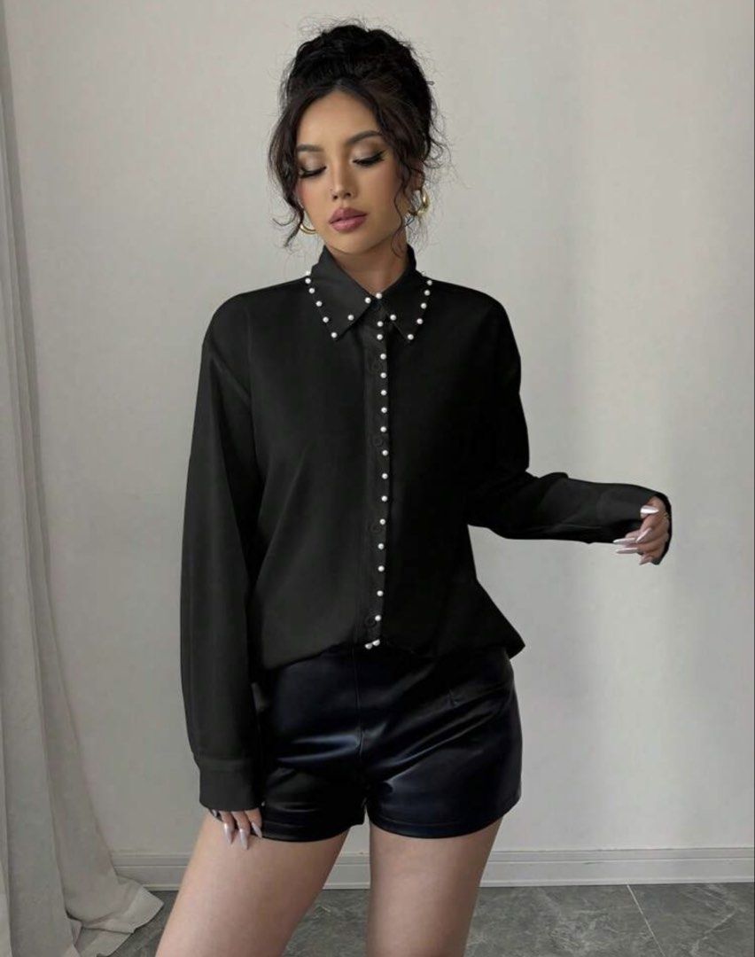 Black Pearl Embellished Button-Up Shirt (Category: Shirts) located in Cebu City. Submitted by iamgee89 (Listing ID 1456475115, Image 1). Description: - Chic black long-sleeve shirt - Exquisite pearl embellishments along the collar and front buttons - Asymmetrical hemline also features pearl detailing - Effortlessly transitions from dressed up to dressed down - Ideal for a sophisticated night out or a stylish daytime ensemble.
