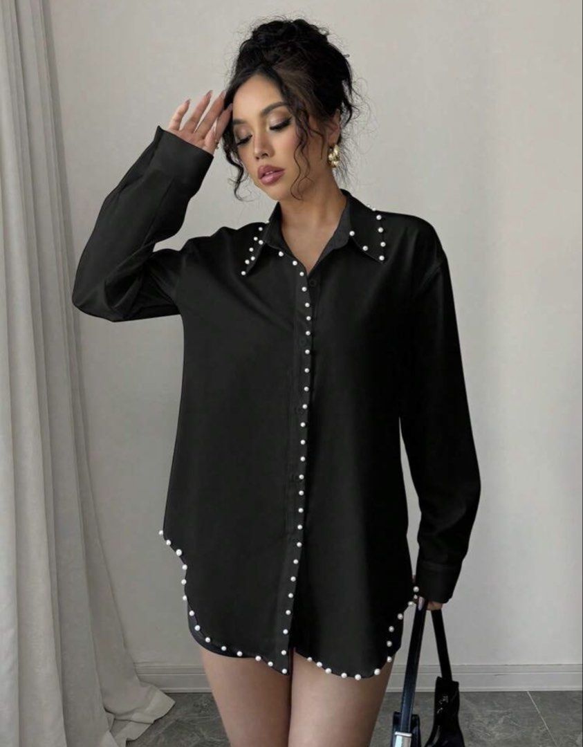 Black Pearl Embellished Button-Up Shirt (Category: Shirts) located in Cebu City. Submitted by iamgee89 (Listing ID 1456475115, Image 3). Description: - Chic black long-sleeve shirt - Exquisite pearl embellishments along the collar and front buttons - Asymmetrical hemline also features pearl detailing - Effortlessly transitions from dressed up to dressed down - Ideal for a sophisticated night out or a stylish daytime ensemble.