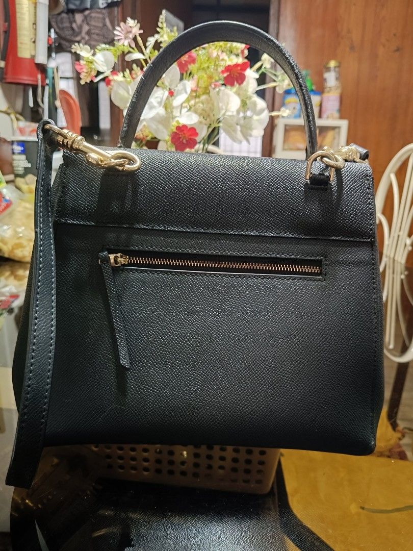 Black Textured Handbag with Top Handle and Shoulder Strap (Category: Shoulder Bags) located in Caloocan City. Submitted by chickencubes (Listing ID 1456434576, Image 3). Description: - Classic black handbag - Textured material for a sophisticated look - Versatile with a top handle and detachable shoulder strap - Convenient back zipper pocket for essentials - Ideal for both daily wear and special events - Timeless and simple design.