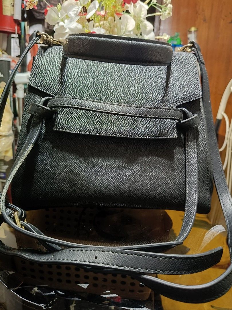 Black Textured Handbag with Top Handle and Shoulder Strap (Category: Shoulder Bags) located in Caloocan City. Submitted by chickencubes (Listing ID 1456434576, Image 2). Description: - Classic black handbag - Textured material for a sophisticated look - Versatile with a top handle and detachable shoulder strap - Convenient back zipper pocket for essentials - Ideal for both daily wear and special events - Timeless and simple design.