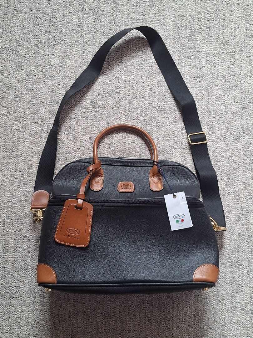 BRIC'S / Black Leather Trim Duffle Bag with Strap (Category: Luxury Bags & Wallets) located in Cebu City. Submitted by thehiddengemsbykid (Listing ID 1456556980, Image 1). Description: Classic black duffle bag with tan leather trim. Zip closure, detachable strap. Lined interior with leather tag. Includes original tags & booklet. Perfect for travel or daily use. Like new / Condition w/ tags Pls check all details posted Don't hisetate to message me