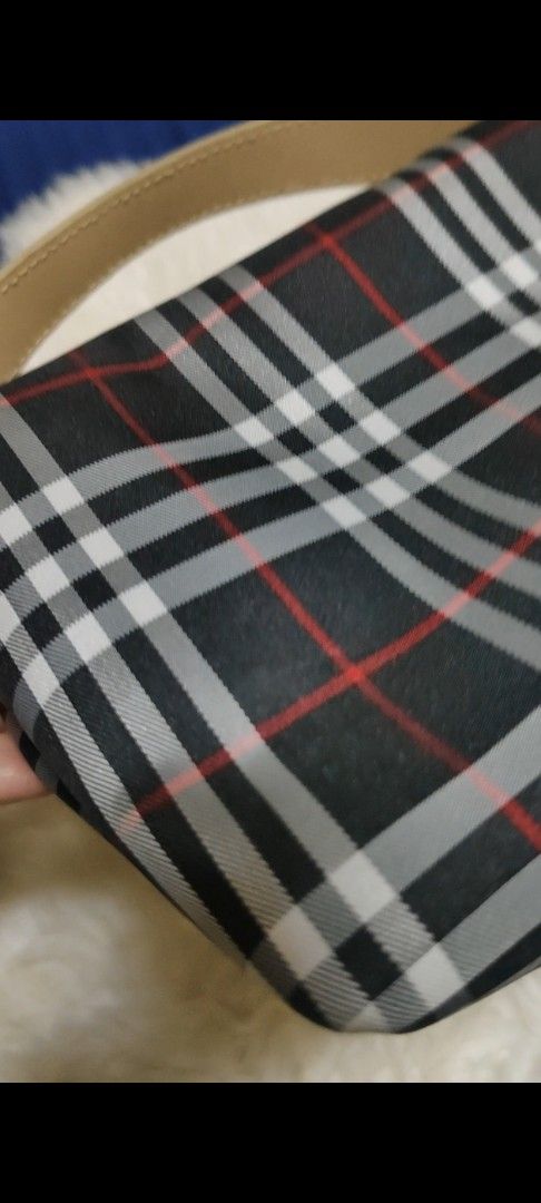 Burberry Nova Check Canvas Leather Trim Handbag (Category: Luxury Bags & Wallets) located in Davao. Submitted by warmdeer-4ae1 (Listing ID 1456558168, Image 2). Description: - Iconic Burberry check pattern (black, white, red) - Beige leather trim and handle - Secure zipper closure - Compact and ideal for carrying essentials - Snap button closure on handle strap - A truly timeless fashion statement.