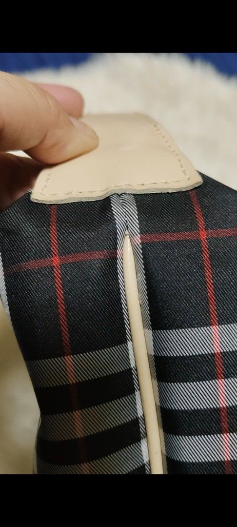 Burberry Nova Check Canvas Leather Trim Handbag (Category: Luxury Bags & Wallets) located in Davao. Submitted by warmdeer-4ae1 (Listing ID 1456558168, Image 3). Description: - Iconic Burberry check pattern (black, white, red) - Beige leather trim and handle - Secure zipper closure - Compact and ideal for carrying essentials - Snap button closure on handle strap - A truly timeless fashion statement.
