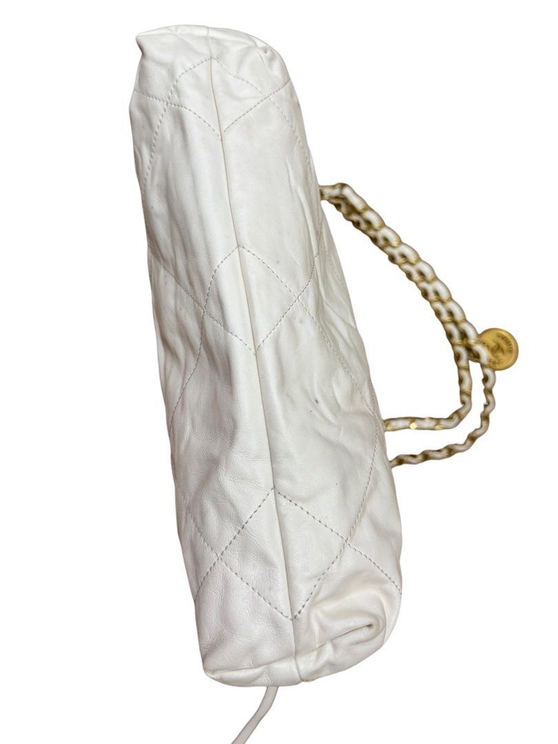 Chanel 22 (Category: Luxury Bags & Wallets) located in San Fernando. Submitted by northerncloset330 (Listing ID 1456549948, Image 3). Description: White Calfskin Hobo Bag Gold Hardware Condition Details: Overall Condition: Preloved. Exterior: The white leather shows visible color transfer, scuffing, and dark marks across the surface (please refer closely to the photos).Hardware: Gold-tone lettering and chains remain bright with minor hairline scr