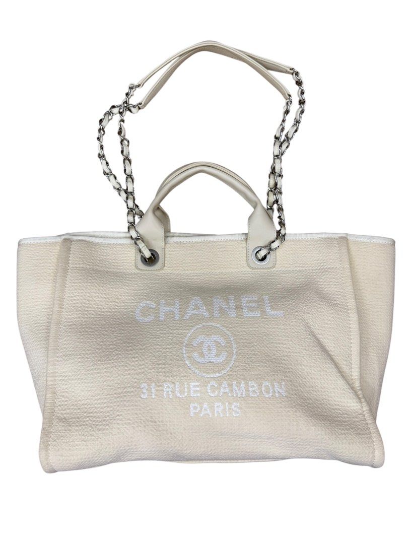 Chanel Deauville Tote (Category: Luxury Bags & Wallets) located in San Fernando. Submitted by northerncloset330 (Listing ID 1456552824, Image 1). Description: seamlessly blends effortless, beach-inspired casualness with high-fashion luxury. Named after the seaside resort town in France where Coco Chanel opened her first clothing boutique, this bag is constructed from a textured cream canvas fabric. The front features the iconic jacquard-woven whi