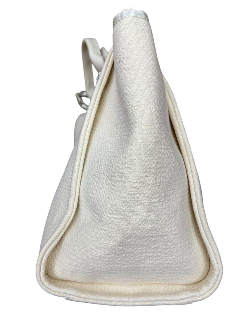 Chanel Deauville Tote (Category: Luxury Bags & Wallets) located in San Fernando. Submitted by northerncloset330 (Listing ID 1456552824, Image 3). Description: seamlessly blends effortless, beach-inspired casualness with high-fashion luxury. Named after the seaside resort town in France where Coco Chanel opened her first clothing boutique, this bag is constructed from a textured cream canvas fabric. The front features the iconic jacquard-woven whi