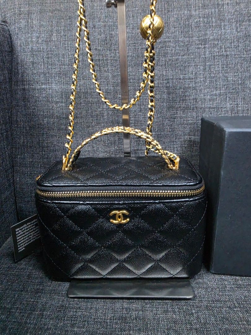 Chanel Vanity Case Bag Black Caviar Gold Hardware (Category: Luxury Bags & Wallets) located in General Trias. Submitted by roselle2230 (Listing ID 1456544474, Image 2). Description: - Authentic Chanel Vanity Case Bag - Color: Black - Material: Caviar Leather - Iconic Diamond Quilting - Signature CC Logo - Gold Chain Strap - Adorable Gold Ball Charm - Interior lined with 'Chanel Made in Italy' tag - Comes with original Chanel Makeup box.
