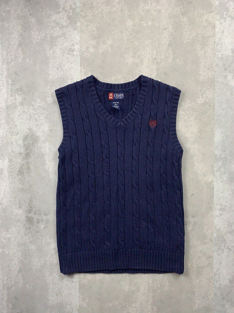 Chaps Navy Blue Cable Knit V-Neck Sweater Vest (Category: Vests) located in Las Pinas. Submitted by hustlathrift (Listing ID 1456422561, Image 1). Description: - Classic navy blue Chaps sweater vest - All-over cable knit detailing - V-neck design - Small embroidered logo on chest - Sleeveless style - Ideal for layering in cooler weather.