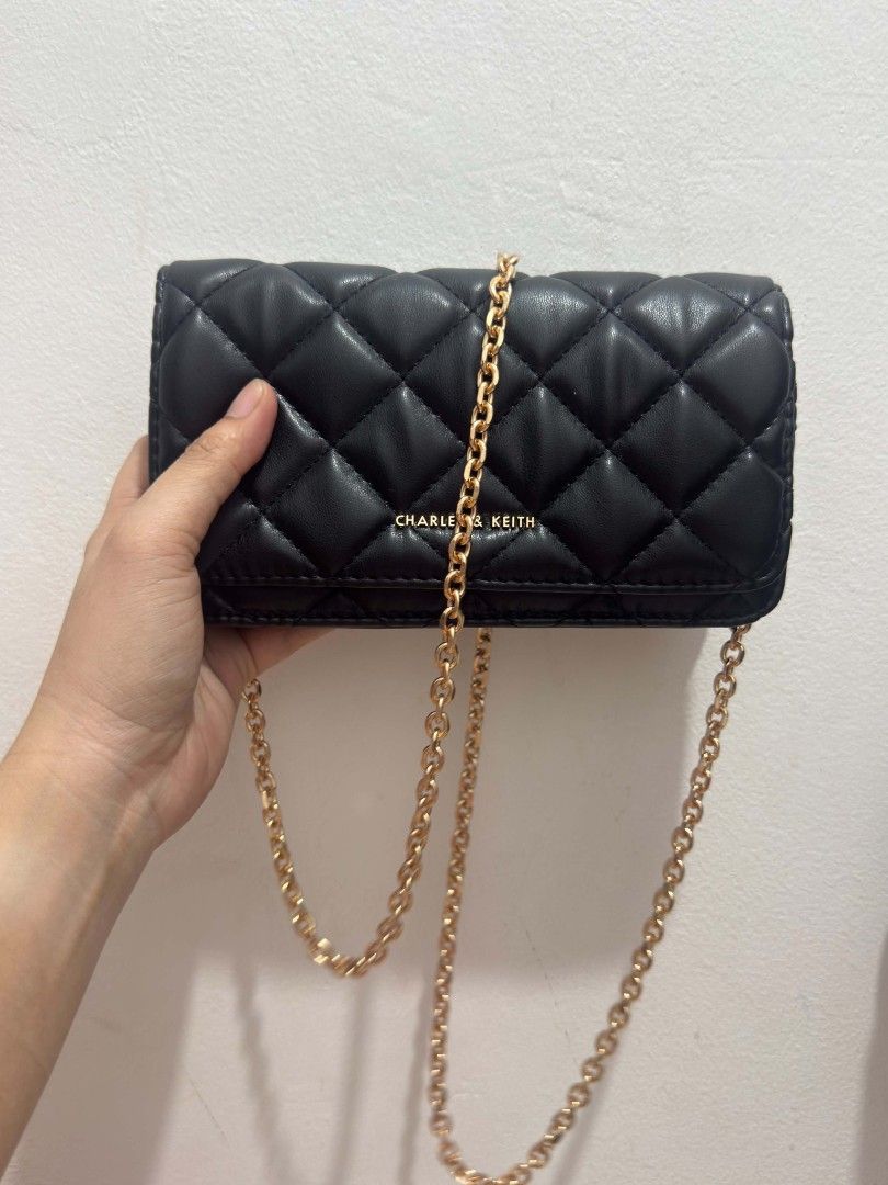 Charles & Keith Black Quilted Wallet on Chain Bag (Category: Luxury Bags & Wallets) located in Manila. Submitted by livedragon-90b6 (Listing ID 1456423230, Image 1). Description: - Brand: Charles & Keith - Color: Black - Material: Quilted - Hardware: Gold chain strap - Style: Wallet on Chain (WOC) - Features: Classic diamond quilting, compact size for essentials - Versatility: Can be worn as a crossbody or shoulder bag - Occasion: Suitable for da