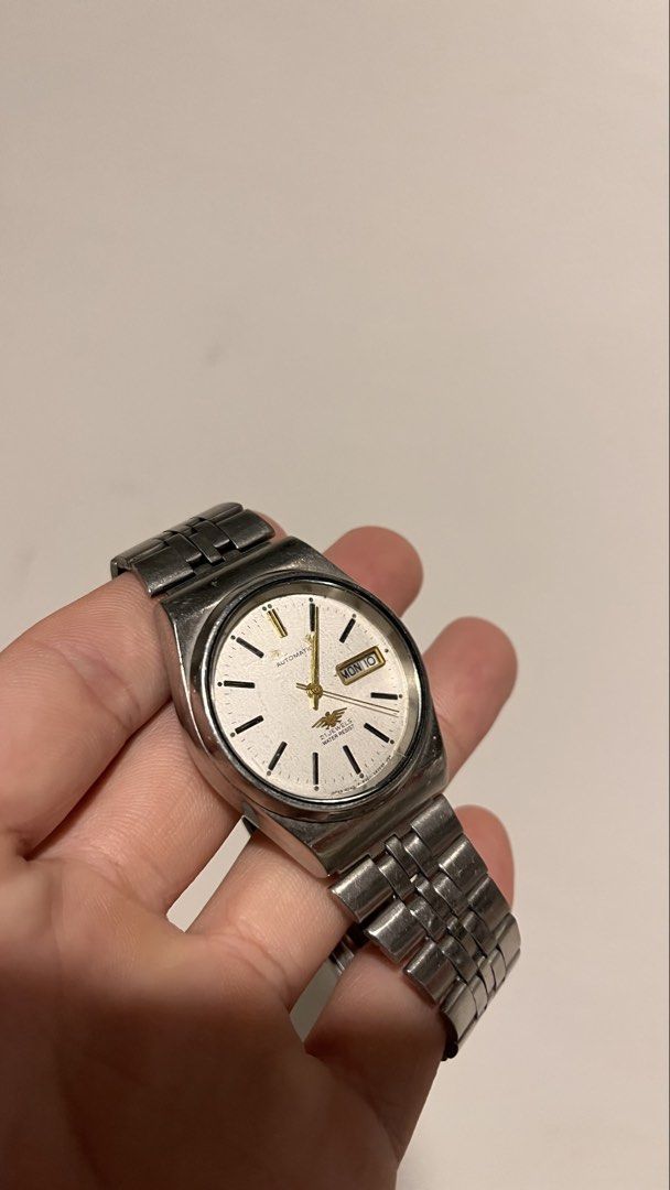 Citizen Eagle 7 Automatic Watch (Not Moving) (Category: Men's Watches) located in Dinalupihan. Submitted by banditvaultco (Listing ID 1456582563, Image 2). Description: Model/Reference 4-039190 HST Serial Number: 076677 Internal Casing Code: GN-4W-S The Face: A white sunburst dial showcasing the gold-tone Eagle 7 logo above the 6 o’clock mark, luminous stick indices, and a Day-Date complication at 3 o’clock. The Body: 35mm–36mm stainless steel ca