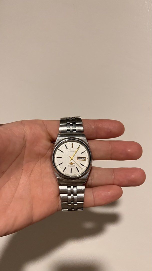 Citizen Eagle 7 Automatic Watch (Not Moving) (Category: Men's Watches) located in Dinalupihan. Submitted by banditvaultco (Listing ID 1456582563, Image 1). Description: Model/Reference 4-039190 HST Serial Number: 076677 Internal Casing Code: GN-4W-S The Face: A white sunburst dial showcasing the gold-tone Eagle 7 logo above the 6 o’clock mark, luminous stick indices, and a Day-Date complication at 3 o’clock. The Body: 35mm–36mm stainless steel ca