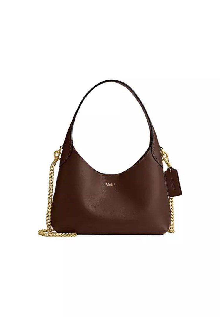 Coach Brooklyn 23 (Category: Luxury Bags & Wallets) located in Muntinlupa City. Submitted by biancaagbscloset (Listing ID 1456586539, Image 2). Description: - Chic Coach shoulder bag - Smooth brown leather - Sleek, curved silhouette - Detachable gold chain strap for versatile styling - Subtle embossed Coach logo on front - Small leather tag detail - Ideal for everyday wear or evening outings.