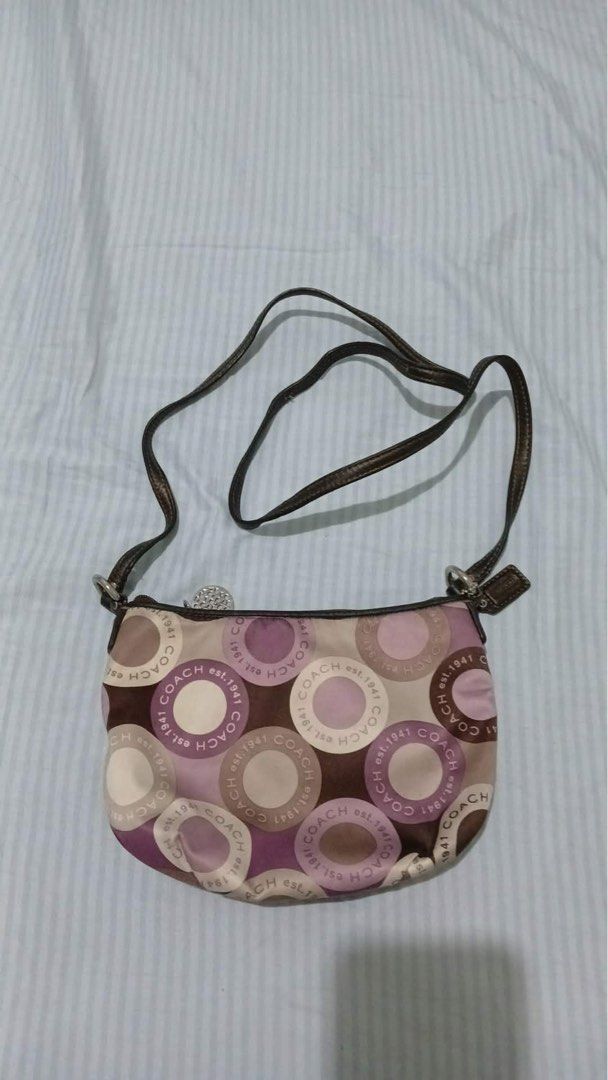 Coach est. 1941 Circle Pattern Shoulder Mini Bag (Category: Luxury Bags & Wallets) located in Quezon City. Submitted by aasspp (Listing ID 1456463937, Image 1). Description: - Cute Coach shoulder bag - Classic circle pattern with 'Coach est. 1941' all over - Brown, adjustable strap - pockets inside.