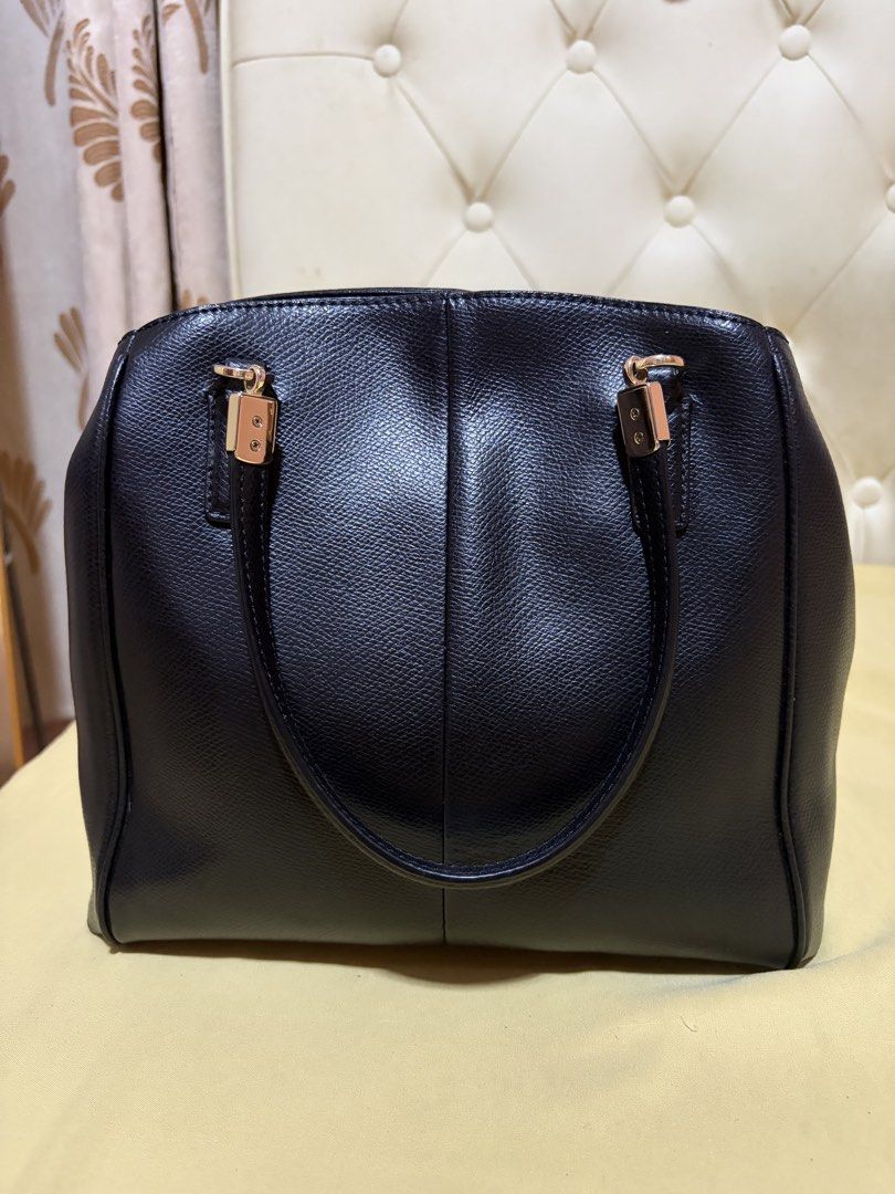 Coach Minetta Satchel (Category: Luxury Bags & Wallets) located in Manila. Submitted by cvmpreloved1212 (Listing ID 1456428029, Image 2). Description: - Classic black Coach leather tote - Elegant gold hardware details - Comfortable top handles - Spacious main compartment - Interior zip pocket for organization - Ideal for daily use and work essentials - with minimal signs of usage - payment first.